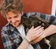 man and his dog showing affection