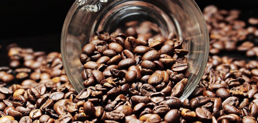 coffee beans spilling out of a coffee cup