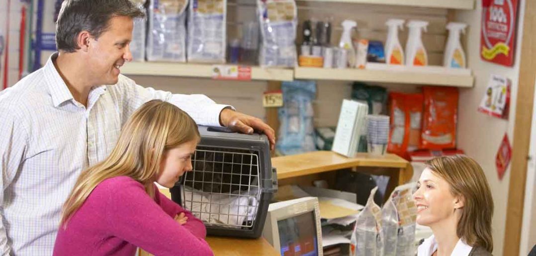 dad and daughter at the vet's office with their cat
