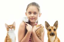 girl with various pets including a dog, a cat, a mouse and a guinea pig