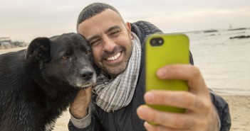 man and dog taking a selfie for social media