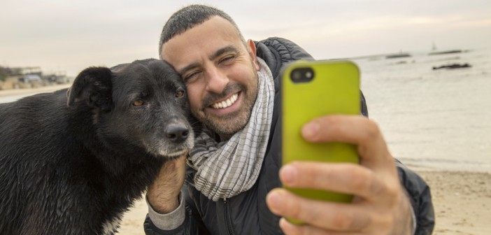 man and dog taking a selfie for social media