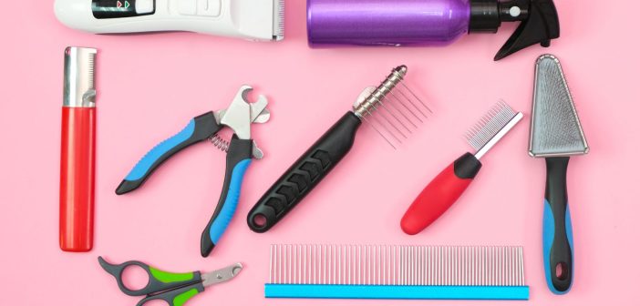 pet grooming tools including a clippers, spray bottle, combs, brushes, and nail clippers