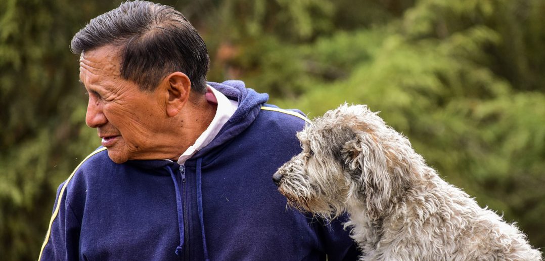 older man with his older dog