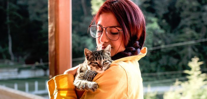 photo of a woman hugging her pet cat